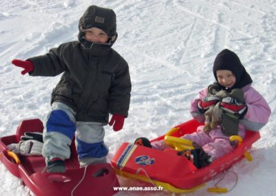 Deux enfants en train de faire de la luge