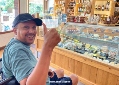 Un vacancier à la fromagerie de Pralognan la Vanoise, lors d'un séjour adapté handicap au centre de vacances Anaé