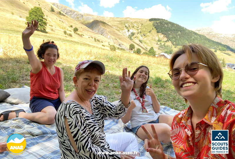 Des vacanciers avec déficience intellectuelle et leurs accompagnatrices de séjour adapté font un pique-nique en pleine nature à Saint Sorlin d'Arves en Savoie